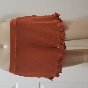 The Boutique s cute and comfy ruffle bottom slip on shorts burnt orange pockets